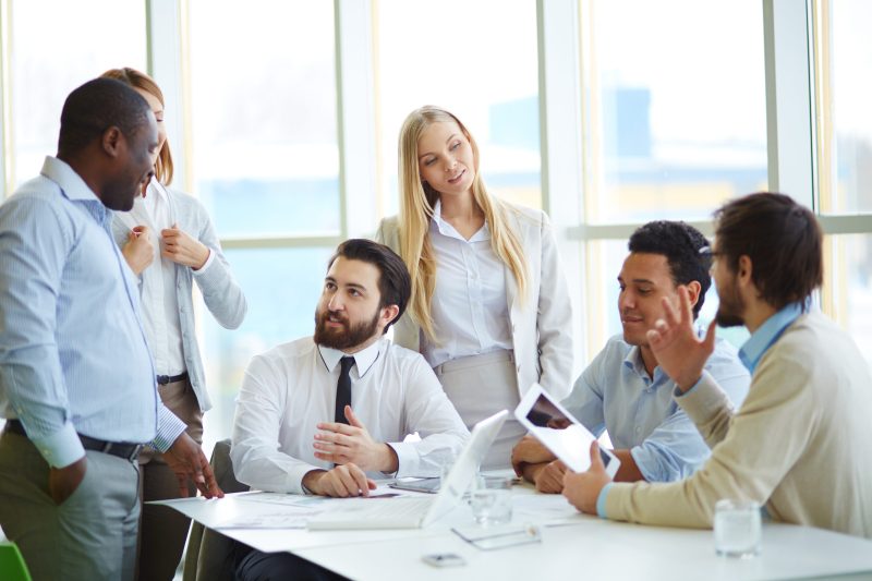 Group of business partners interacting in office